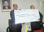 Finance Minister James Musoni receives the cheque from COMESA Secretary General Sindiso Ngwenya. (Photo J. Mbanda)