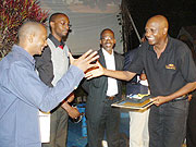 All smiles as Kabera (L) recognises one of the sponsors. 