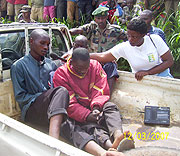 The three murder suspects arrive aboard a pickup at the burial ceremony of the deceased last Saturday. (photo/ A.Gahene)