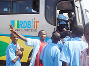 Ecstatic students board one of the ICT buses (Photo D.Sabiiti)