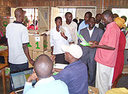 Mayor Nyangezi flanked by teachers tour Inyange  Primary School computer server room. (Photo /A.Gahene)