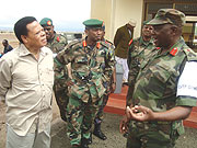 A Ugandan senior army officer makes a point to Juma Mwapachu during his visit to just concluded joint Ex Mlima Kilimanjaro exercise as Rwandau2019s Brig Gen Norbert Kalimba (C) looks on.