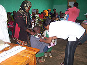 A nurse vaccinates a child at Gacurabwenge Cell during the ongoing immunisation programme. (photo/ A.Gahene)