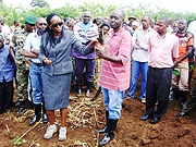Minister of Agriculture, Dr. Agnes Kalibata examines a banana sucker. This was during her tour of Rwamagana yesterday. She advised farmers on proper methods of banana growing.(Photo/ S. Rwembeho)