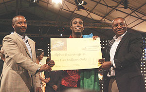 Rwandau2019s envoy to Kenya William Kayonga (left) joins East Africa Breweries  Limited Group Managing Director Mr Seni Adetu (right) in presenting the Tusker Project Fame 3 Winners Kshs 5 million dummy cheque to Rwandau2019s Alpha