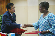 The Minister of Foreign Affairs RoseMary Museminari, shakes hands with China Ambassador Sun Shuzhong.