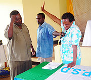 Mujawakigeli swearing in as the new party secretary in Eastern Province. On the left MP Juvenal Nkusi administering  the oath. (Photo/ S. Rwembeho)