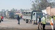 A convoy of Rwandan and Burundian Soldiers drives past Sonatubes on the way to Uganda. (Photo/ J Mbanda)