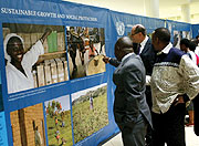 UN Resident coordinator Aurelien Agbenonci (L) and  other UN officials admire some photos at the exhibition. (Photo/ J Mbanda)