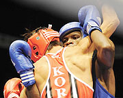 Bikorimana battles with Korean Park Kwan during the 2009 AIBA World Championship las month in Milan.