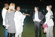 Cobra (in a white African outfit) having a chat with his guests. 