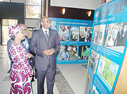 Minister James Musoni and UN Deputy SG Asha Rose Migiro admire a mini photo exhibition highlighting UN activities at the just-cocluded meeting (File Photo)