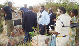 Everready Nkya, (in black T-shirt), a Tanzanian national who buried the Genocide remains, takes a team of CNLG officials around the burial site in Ngara district, Tanzania. (Courtesy photo).  