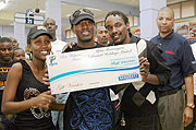 Alpha recieves a dummy cheque at the Nakumatt store in Kigali (Courtsey Photo)