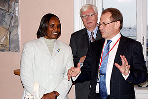 Speaker of Parliament, Rose Mukantabana shares a word with her Swedish counterpart, Per Westerberg while the Secretary General of the Swedish Parliament, Anders Forsberg looks on. (Courtesy photo)
