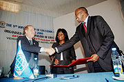 Finance Minister James Musoni shaking hands with DFIDu2019s Richard Arden as World Bank Country Manager Mimi Ladipo looks on after the signing. (Photo/ J. Mbanda)
