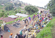 Gihembe Refugees transacting businesses with local residents along a narrow path leading into the camp. (Photo: A. Gahene)