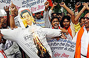 Activists of Shiv Sena, a Hindu hardline group, shout slogans as they burn an effigy of Chinau2019s President Hu Jintao during a protest against the Chinese government in New Delhi.