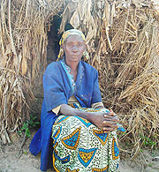 A woman sits infront of her grass thatched hut in Gisagara district. many residents in Rwaniro Sector still live in such dwellings. (Photo/ P. Ntambara)