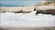 A large pipe belching  sludge  on the beach south of Gaza City.