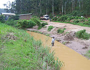 A man takes sand from River Rusine as a truck waits to load. Many residents abuse the river. (Photo /A Gahene)