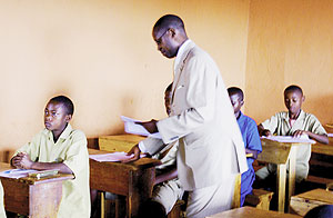 State Minister for Primary and Secondary Education, Mathias Harebamungu, distributes Examination papers.(Photo MINEDUC)