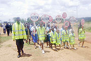 Police leads pupils  in the road safety campaign.(Photo: G. Mugoya)