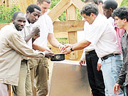 Teachers from the two schools inspect the solar stove equipment. (Photo: J.P Bucyensenge)