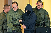 Defendant Alex W. is brought into a courtroom in Dresden on Oct. 26, 2009 on the second day of his trial for the stabbing of Marwa el-Sherbini