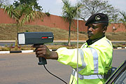 A traffic officer using a speed gun