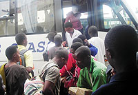 Students scramble to board one of the buses. 