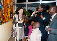 Karin Kathofer showing art to guests during the exhibition.