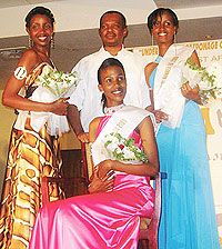 State Minister for Minerals and Natural Resources, Vincent Karega, stands behind Miss East Africa Rwandan chapter 2009 Cynthia Akazuba seated, Annet Mahoro (left) 1st runner-up and the 2nd runner-up.