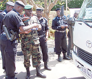 Police Commisioner  General, Emmanuel Gasana, being given stickers at the launch of the road safety week