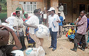 Returnees from Uganda getting food supplies upon their arrival a few months ago. (File Photo)