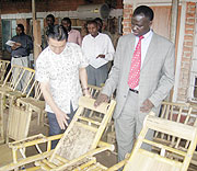 Chinese Economic expert, Wang Qin shows Hon. Stanislas Kamanzi some of the products.