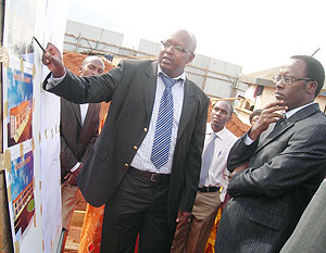 Governor  Fidele Ndayisaba (R) being briefed about the complex by a cooperative member. (Photo: P. Ntambara)