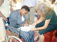 A lady learns how to write using a prosthetic hand, the beneficiaries from Rubavu will be able to perform such tasks with their newly acquired artificial  hands. (Photo: P. Ntambara)