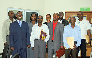 The departing trainees in a group photo with Program Coordinator Alexis Ndayisaba (L) after a briefing yesterday.