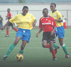 Winger Jacqueline Nabana tries to dribble round Ugandan defender Gladys Nakitto yesterday.