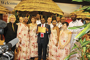 Ambassador Claver Gatete  (centre) displaying the plaque awarded to Rwanda as the best exhibitor. (Courtsey Photo)