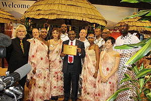 Ambassador Claver Gatete  (centre) displaying the plaque awarded to Rwanda as the best exhibitor (Courtsey Photo)