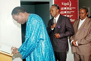 Benin Higher Education and Scientific research Minister Prof. Francois Abiola,signs the visitosu2019 book at Kigali Genocide memorial centre.(Photo J Mbanda)