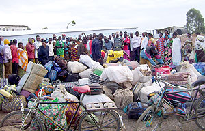 Returnees sort out their belongings at Rukomo transit camp. (File Photo)