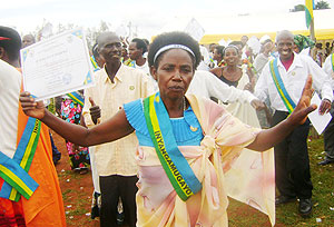 Gacaca judges dance happily as they display certificates of merit. (Photo: S. Rwembeho)