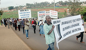 MAKING THE LONG WALK: Demonstrators making their way to the the ICTR Offices in Remera yesterday. (Photo J. Mbanda)