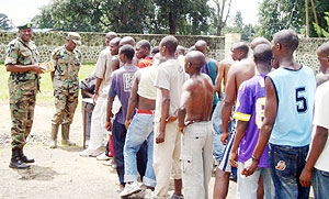 Major Charles Karangwa (left) inspects the recruitment exercise in Musanze stadium. (Photo: B. Mukombozi)