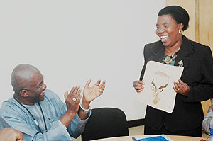 UNAIDS Country Coordinator Dr. Amadou Mbaye (L) admires a gift from Hon. Lidiana Mafuru Mngu2019ongu2019o   who led the Tanzanian Parliamentarians. (Photo J Mbanda)