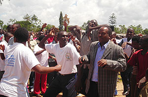 Jean Baptiste Habyarimana (in jacket) of the NURC joins youths in a dance during the opening of the Itorero in Huye district. (Photo: P. Ntambara)
