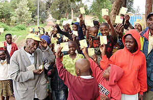 Residents display their health insurence cards. 